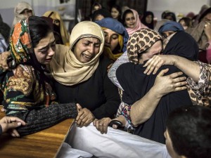 A family mourns the death of their child │Photography: Reuters – Read: The Peshawar Tragedy: A Tanqeed Statement