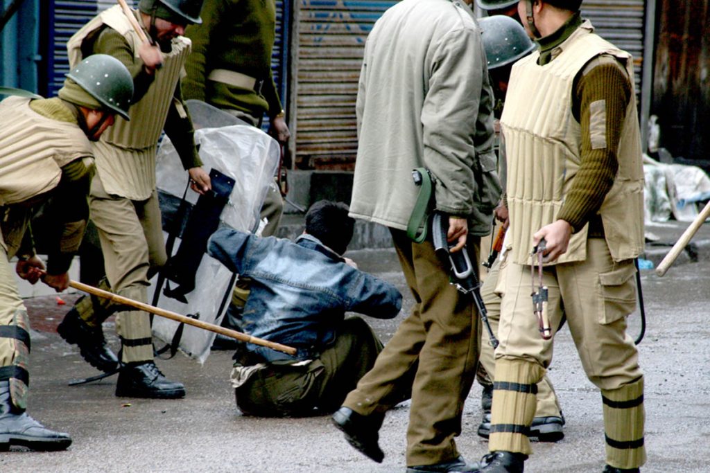 Kashmiri protester being beaten by Indian security forces with a brick and bamboo sticks as they detain him during a protest in Srinagar. March 27, 2009. 